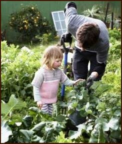 Man and daughter checking for garden pests and diseases