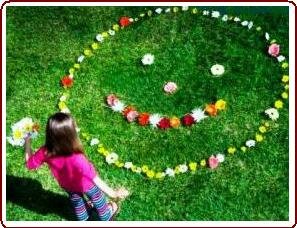 Teaching nature to kids - young girl making a flower face