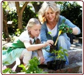 Teaching nature to kids - Mother and daughter in garden