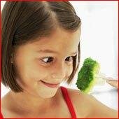 Broccoli growing-girl holding broccoli on fork