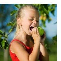 Growing fruit girl eating apple