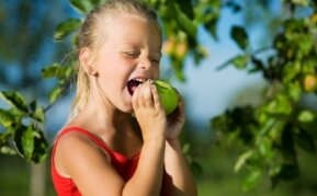 Grow your own fruit, girl eating apple