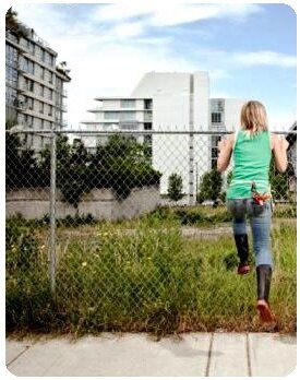 Woman planting in city weed plot